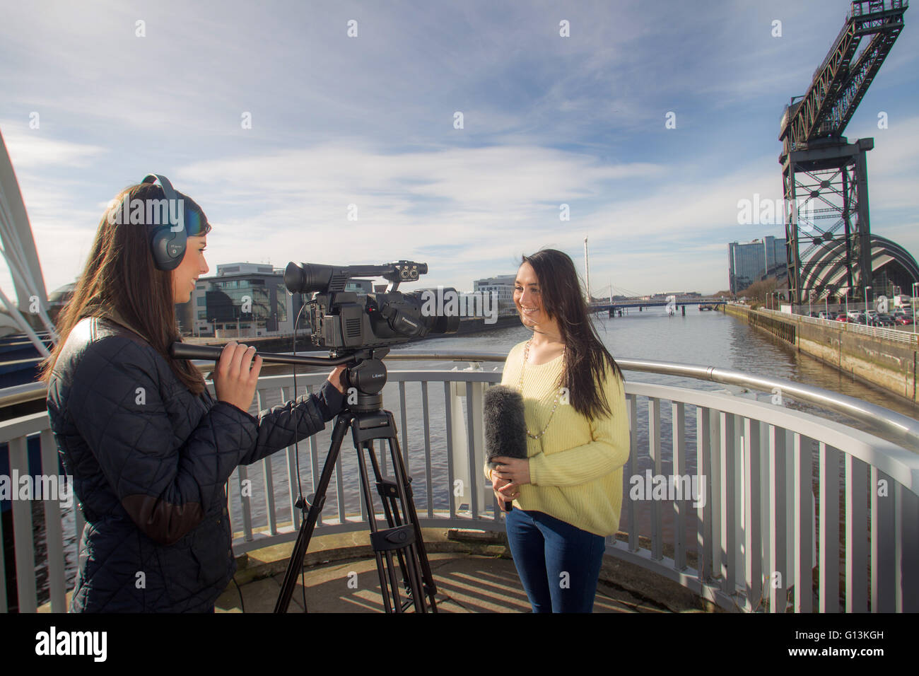 Media students filming in Glasgow by the river clyde Stock Photo