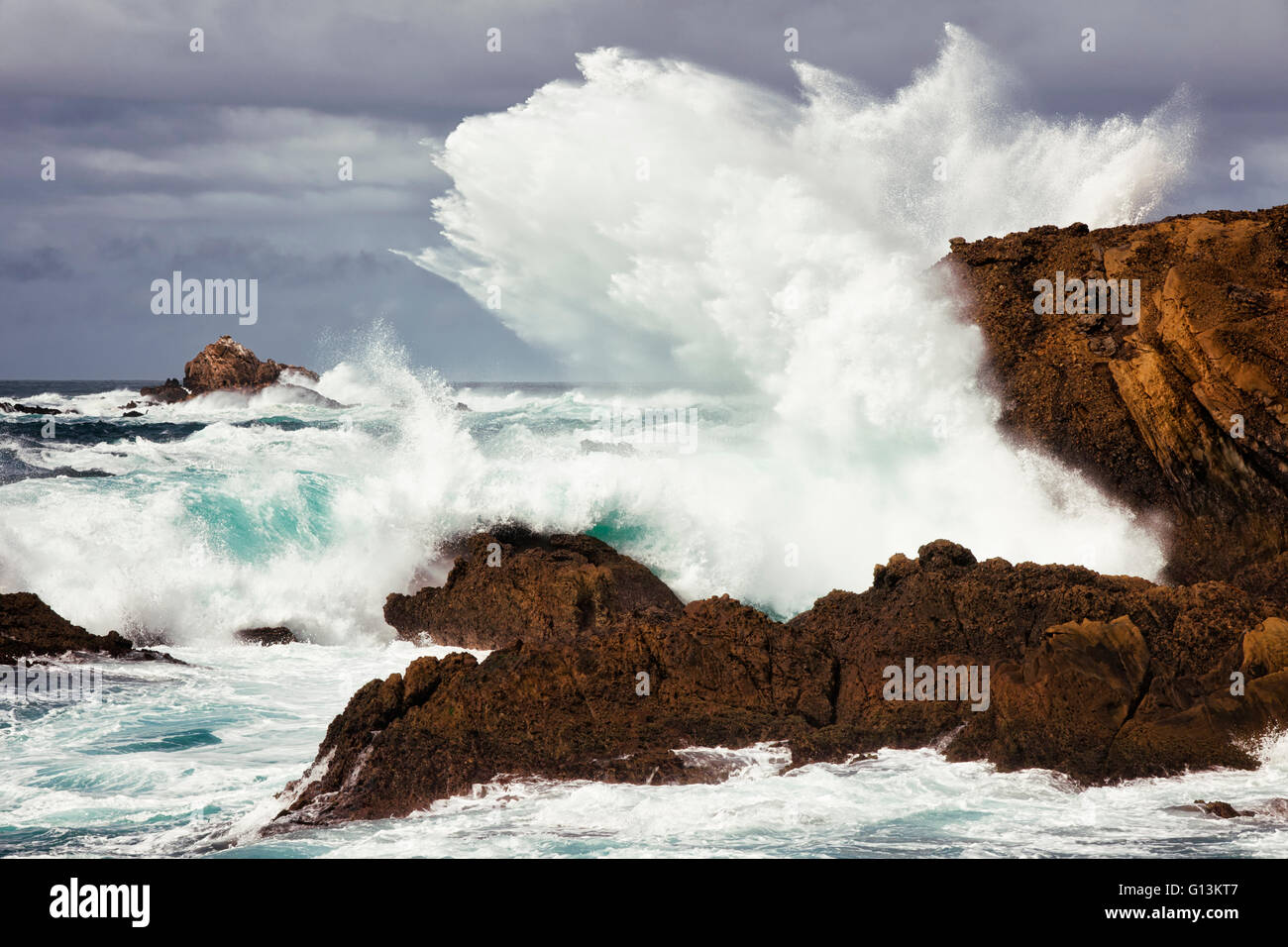 Massive waves explode against the cliffs at Point Lobos State Natural Reserve on California’s Big Sur coastline. Stock Photo