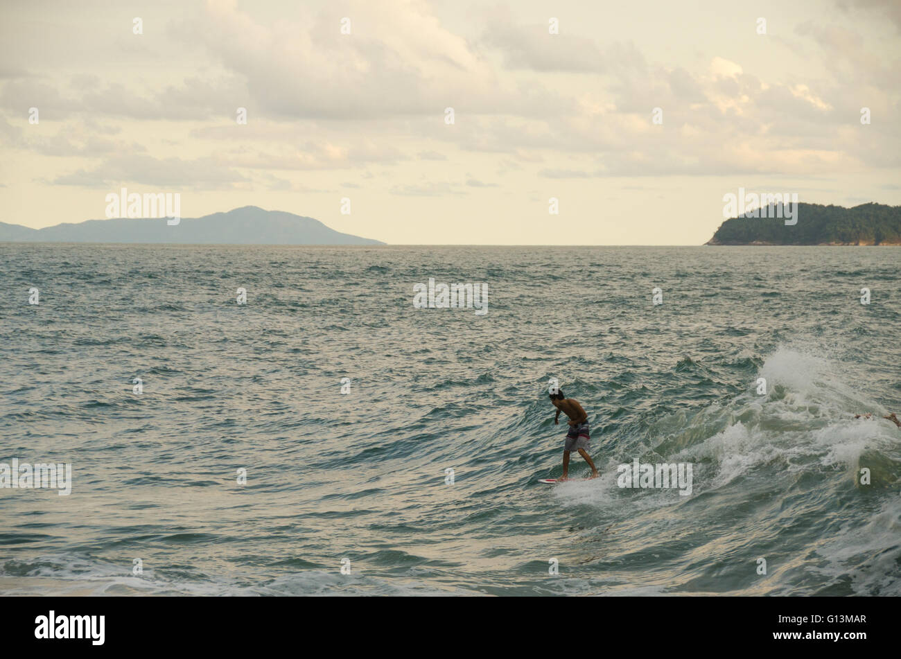 Surfer riding a wave Stock Photo - Alamy