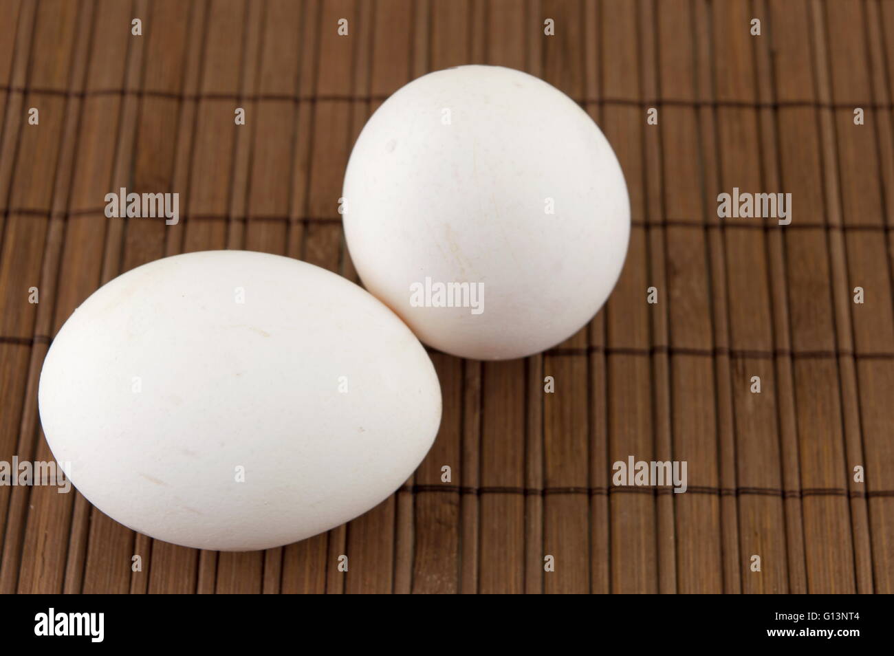 Fresh white eggs on bamboo table Stock Photo