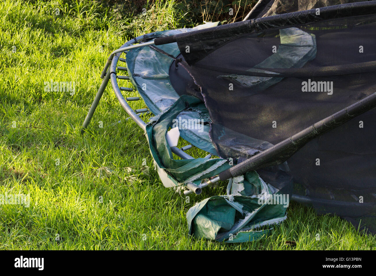 Trampoline Ripping Details of a storm damaged trampoline on green reserve alongside ...