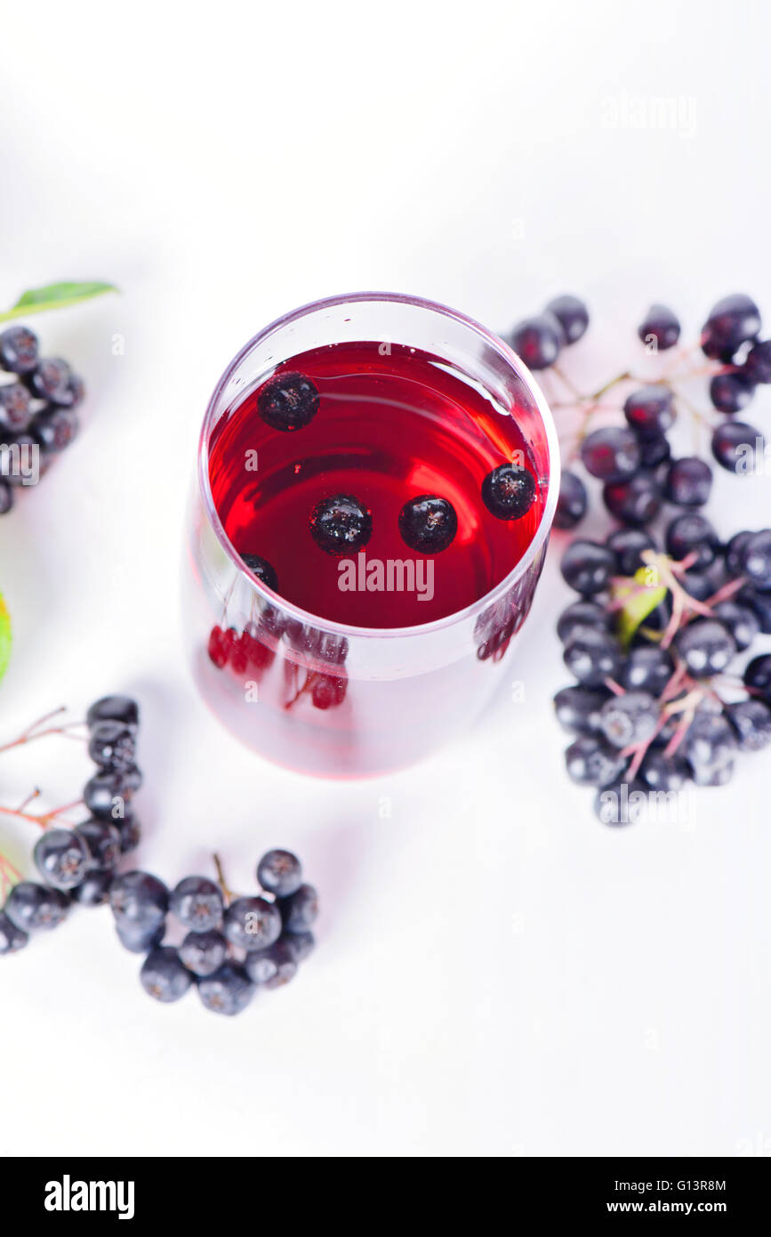 Glass of aronia juice with berries, overhead view Stock Photo