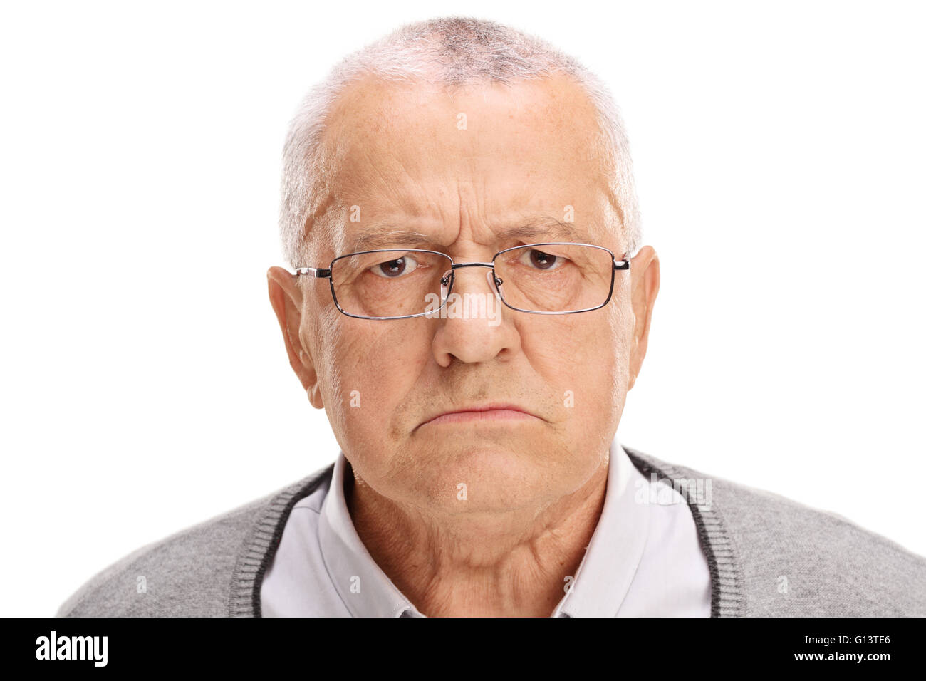 Portrait of an angry senior frowning and looking at the camera isolated on white background Stock Photo