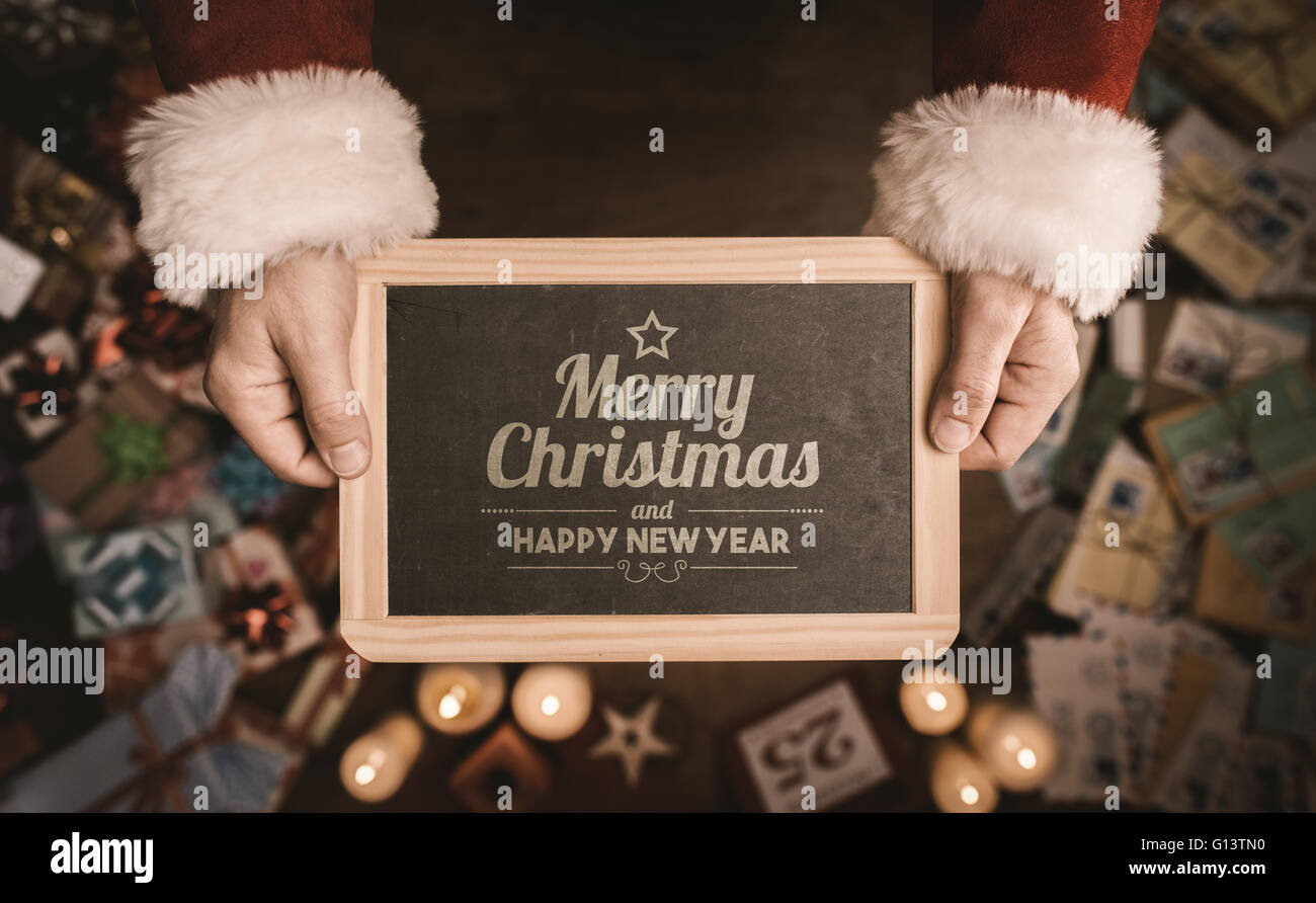 https://c8.alamy.com/comp/G13TN0/santa-claus-holding-a-blackboard-with-merry-christmas-and-happy-new-G13TN0.jpg