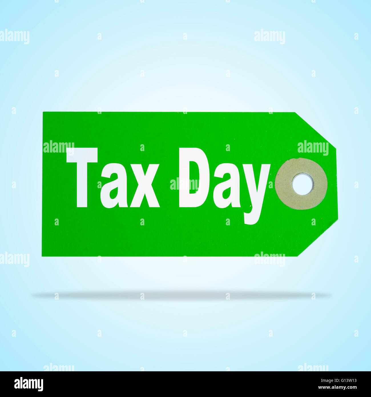 sentence tax day written in a green paper label Stock Photo