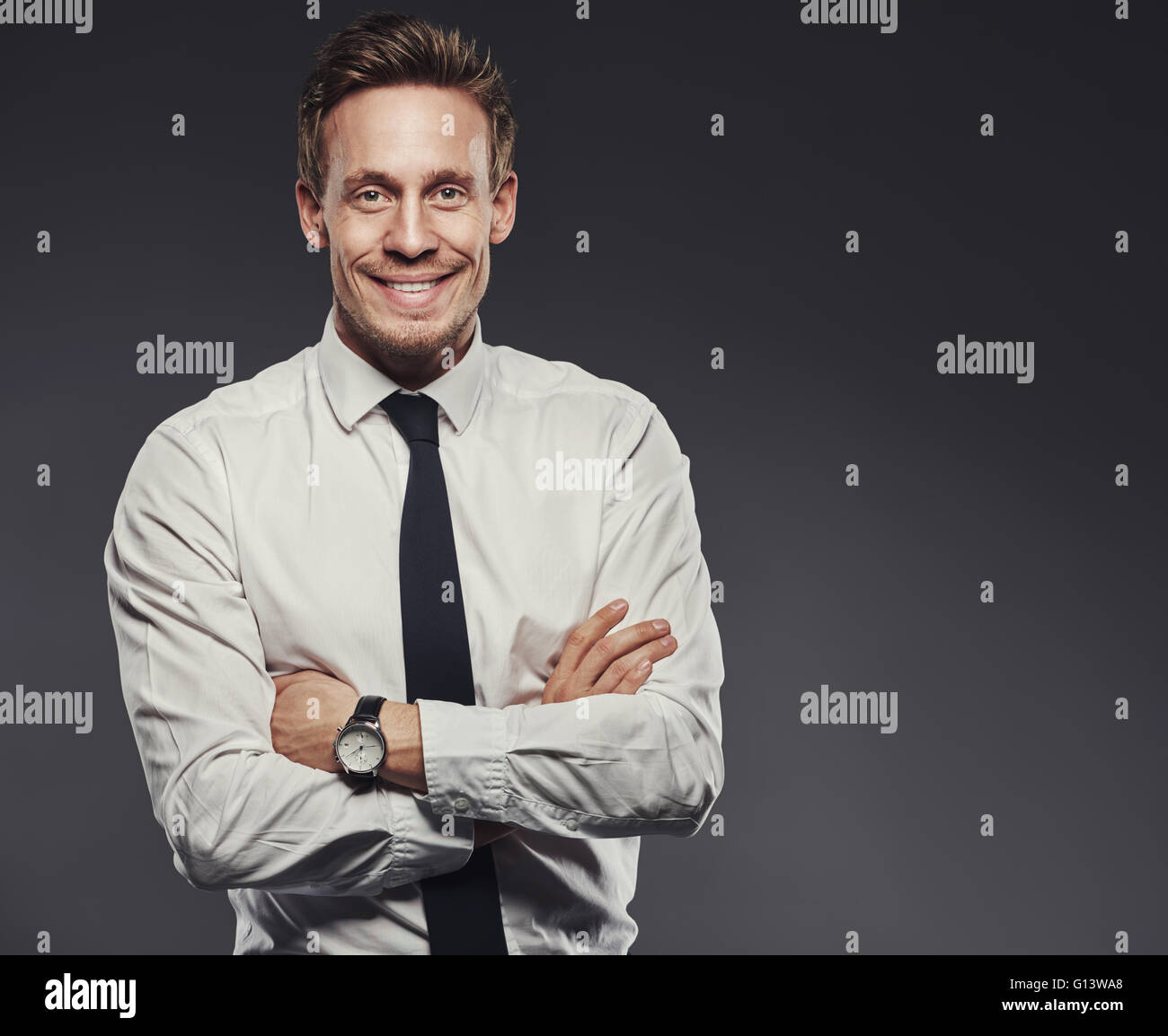 Young man suit grey arms folded hi-res stock photography and images - Alamy