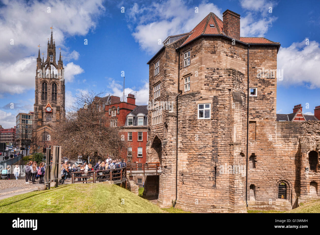 The Black Gate, entrance to old Newcastle,  with a party of students waiting to go inside. On the left is  Newcastle Cathedral Stock Photo