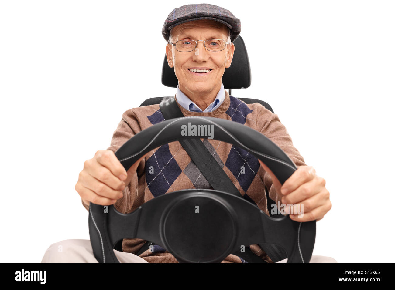 Studio shot of a senior driver holding a steering wheel and looking at the camera isolated on white background Stock Photo