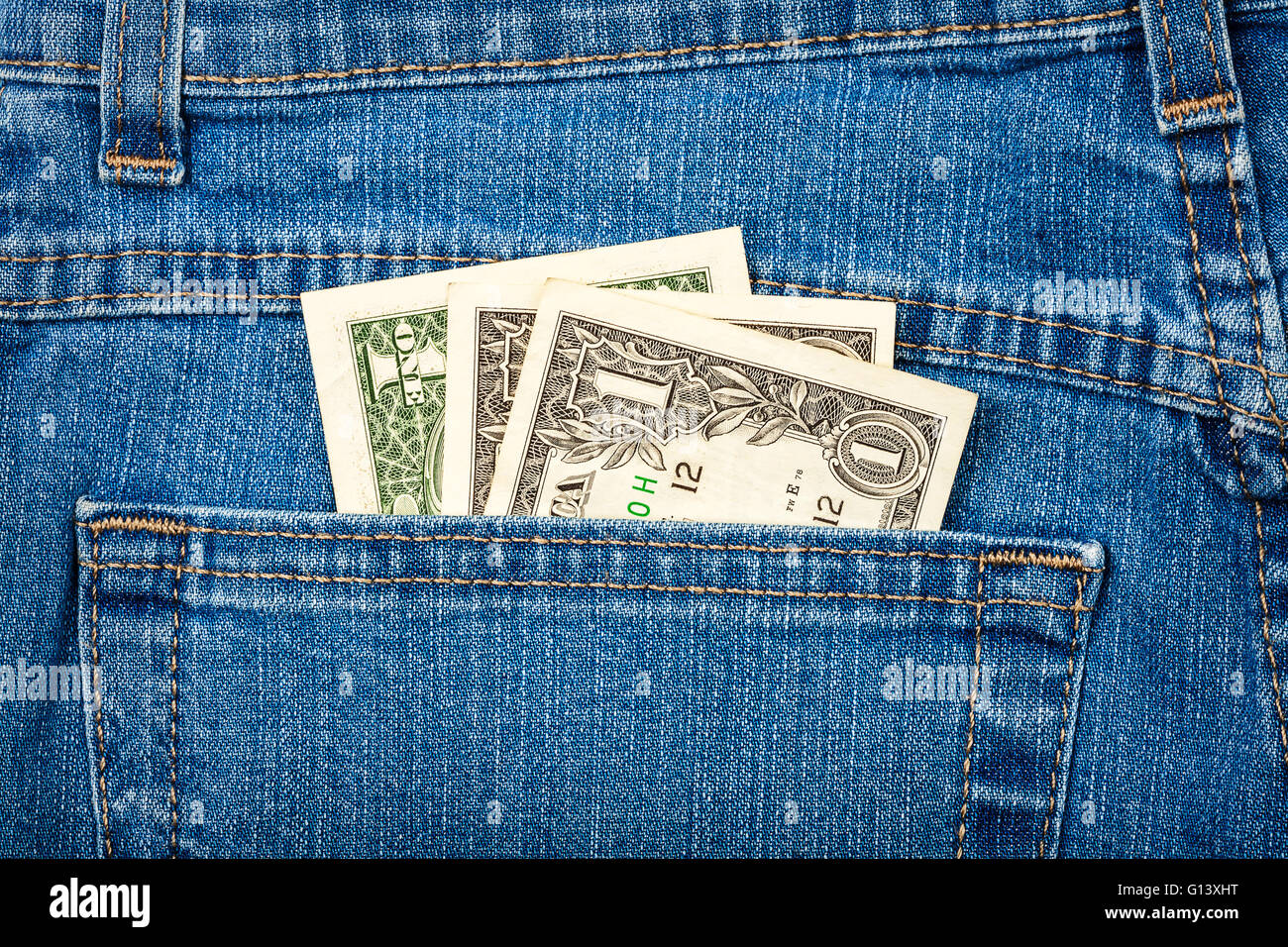 Just three American dollars in jeans back pocket Stock Photo Alamy