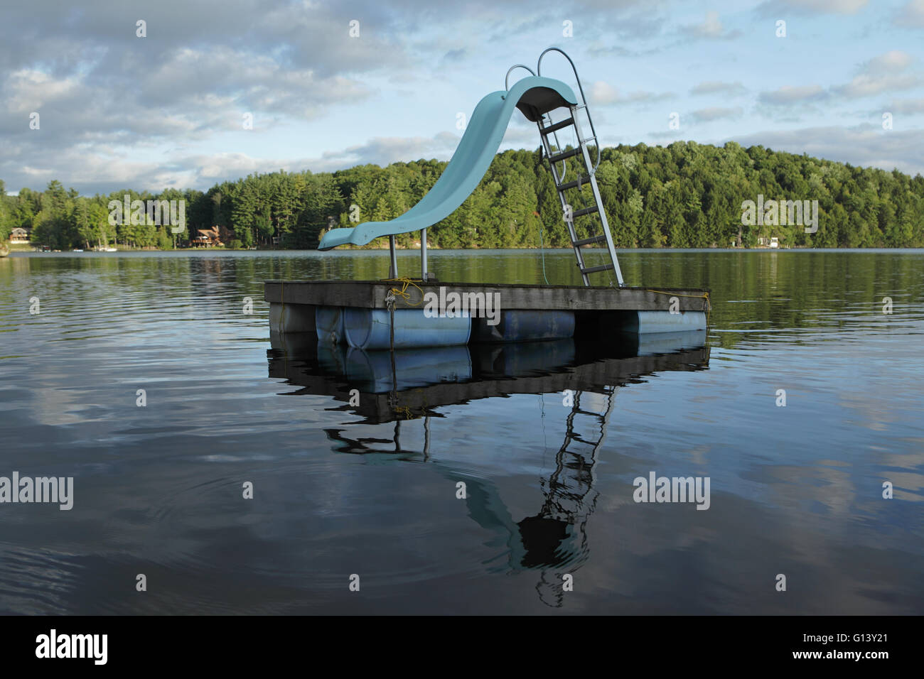 Old diving slide floating platform on a Vermont lake in the summer