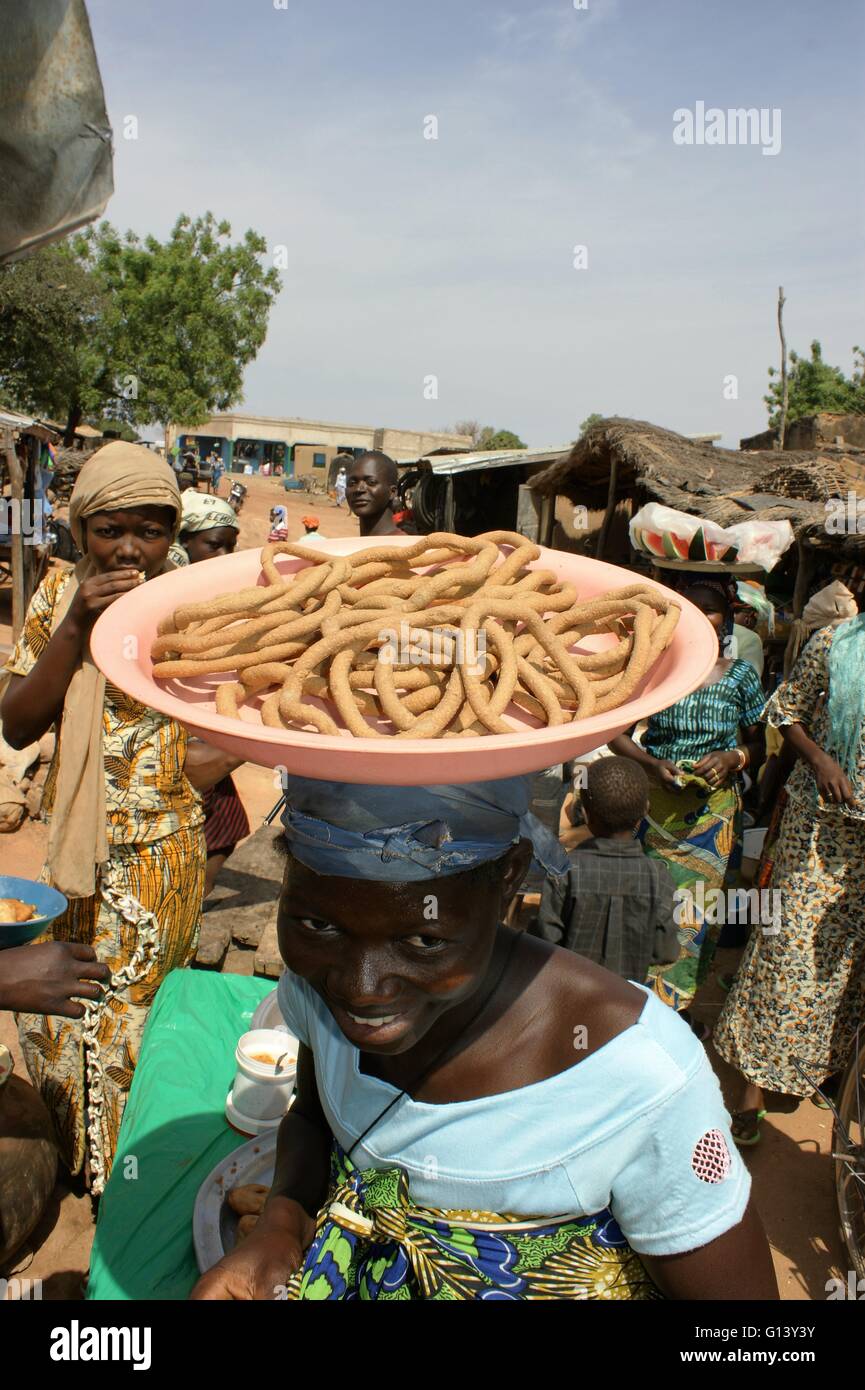Women food vendor at  a busy market, in Burkina Faso, West Africa. Stock Photo