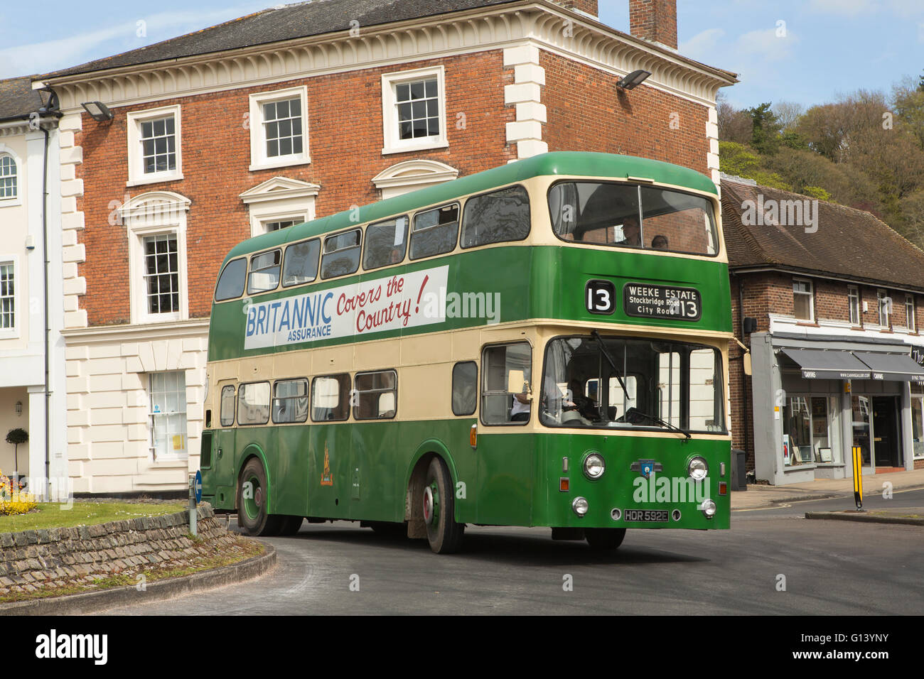 British Leyland bus on the road in Winchester. Green livery shinning in the summer sun. Great movement as the bus turns a corner Stock Photo