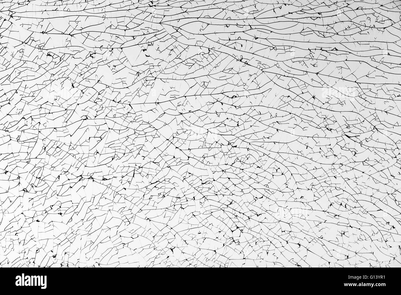 Broken glass with cracks pattern, monochrome background texture Stock Photo