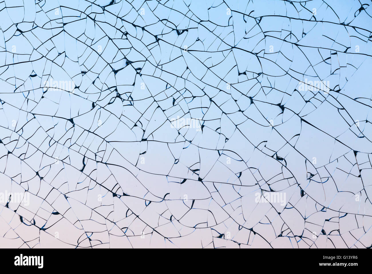 Broken glass texture with cracks pattern over blue background Stock Photo