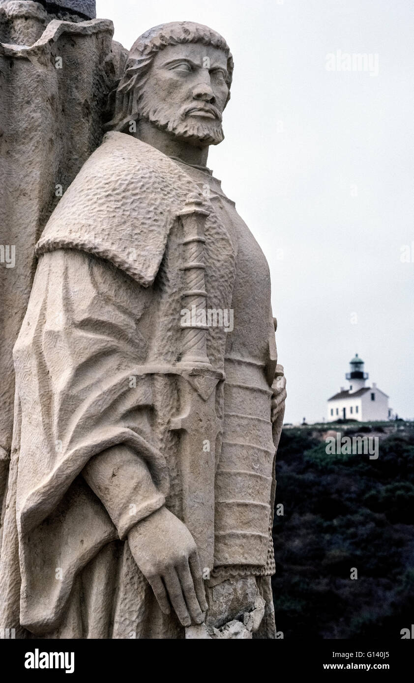 A statue of Juan Rodriguez Cabrillo honors the discoverer of California while on a Spanish expedition in 1542 and stands at the southern tip of the state on Point Loma in San Diego, California, USA. The Cabrillo National Monument was carved in Portugal by sculptor Avaro de Bree for display at the 1939 international exposition in San Francisco. The sandstone statue was later moved to this site near the Old Point Loma Lighthouse (background) that was erected in 1854 on a hilltop 422 feet (129 meters) above sea level. Stock Photo