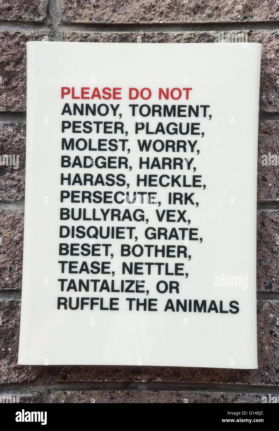A simple but intriguing sign with an extensive list of words asks visitors not to mistreat the animals at the world-famous San Diego Zoo in San Diego, California, USA. It politely requests zoogoers not to annoy, torment, pester, plague, molest, worry, badger, harry, harass, heckle, persecute, irk, bullyrag, vex, disquiet, grate, best, bother, tease, nettle, tantalize or ruffle the more than 3,500 rare and endangered animals living there. Stock Photo