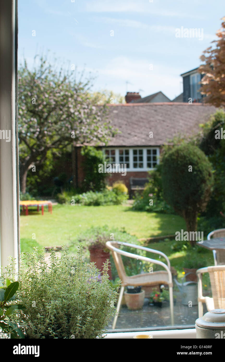 Garden scene viewed from inside a window on a summer day Stock Photo