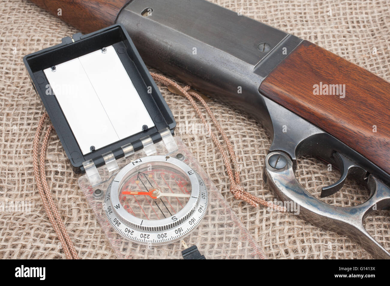 Closeup view of hunting rifle and compass Stock Photo