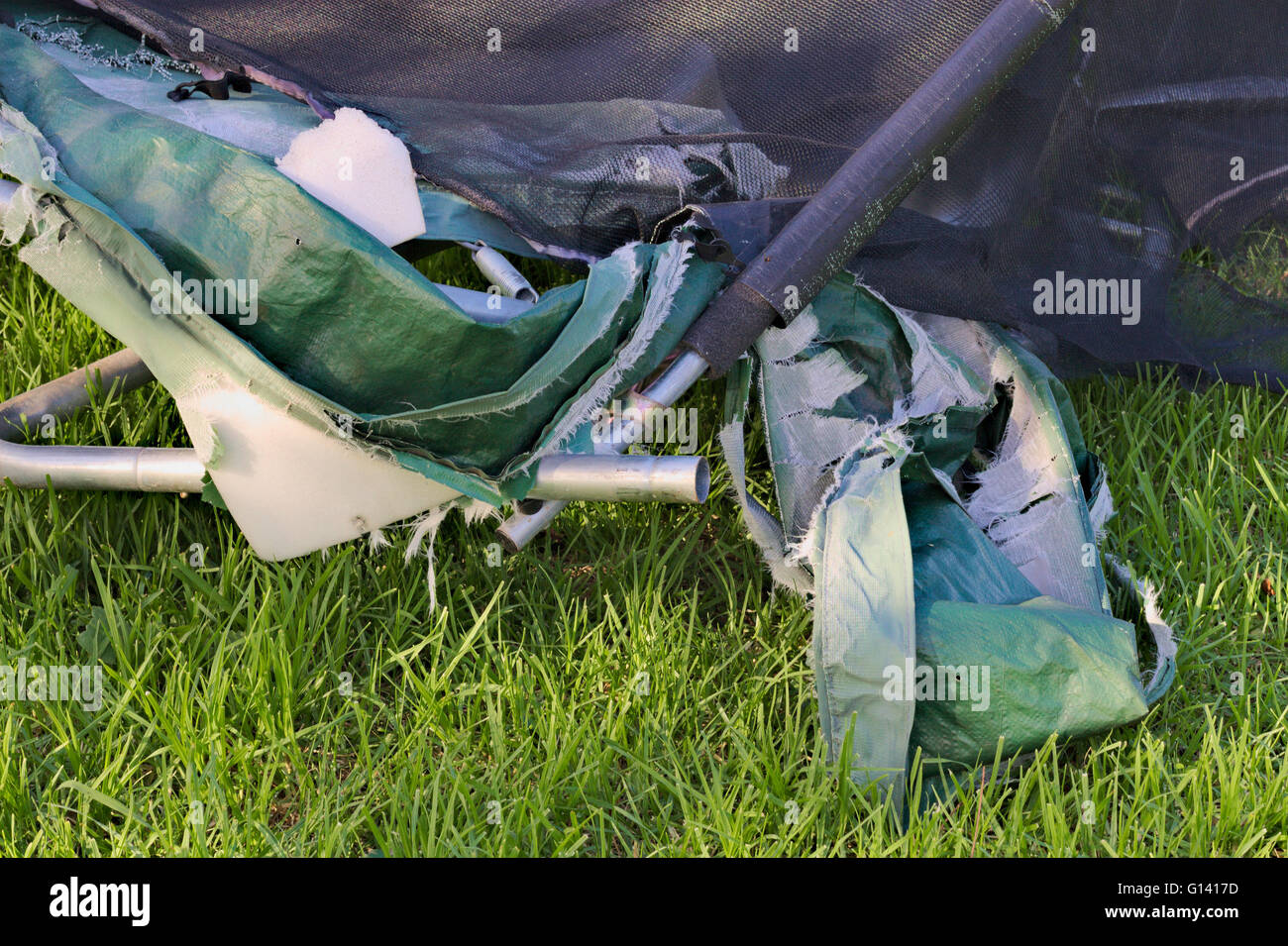 Detailed parts of a damaged trampoline on a grassy background Stock ...