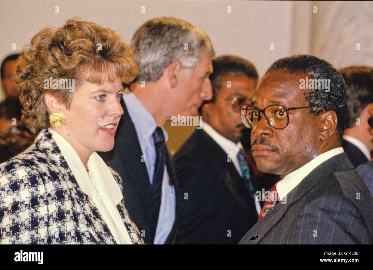 Virginia Thomas, left, and Judge Clarence Thomas, right, during a break in the testimony of Professor Anita Hill as Hill testifies before the United States Senate Judiciary Committee on Judge Thomas' confirmation to be Associate Justice of the US Supreme Court in Washington, DC on October 11, 1991. US Senator John Danforth (Republican of Missouri) is at the center of the image. Credit: Arnie Sachs/CNP Stock Photo