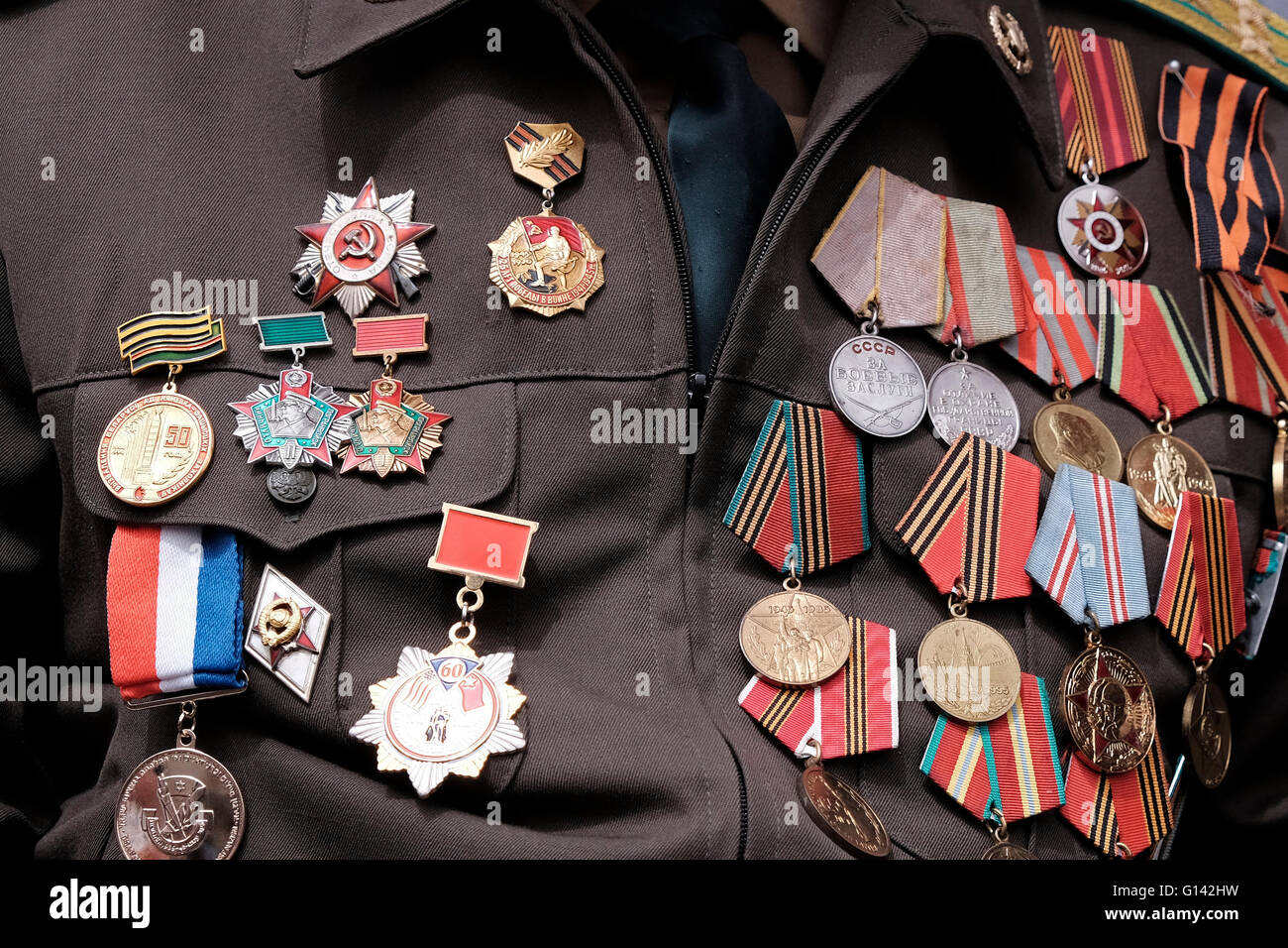 A soviet Jewish World War II veteran with medals pinned in his old uniform during ceremony marking the Allied Victory over Nazi Germany in Israel Stock Photo