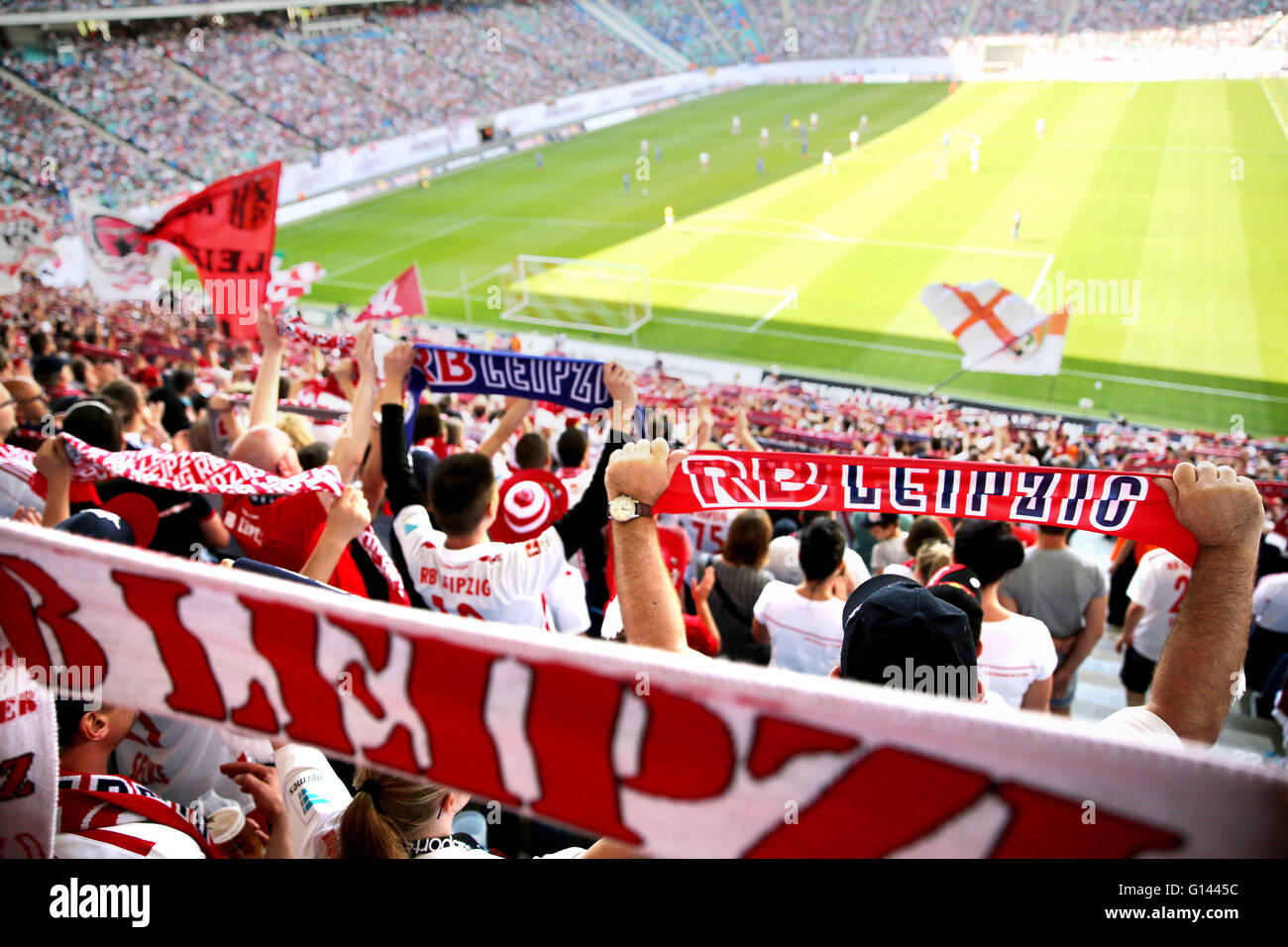 Leipzig, Germany. 08th May, 2016. Supporters cheer for their teams from the viewing stands at the German second division Bundesliga soccer match between RB Leipzig and Karlsruhe SC at the Red Bull Arena in Leipzig, Germany, 08 May 2016. Photo: JAN WOITAS/dpa (EMBARGO CONDITIONS - ATTENTION: Due to the accreditation guidelines, the DFL only permits the publication and utilisation of up to 15 pictures per match on the internet and in online media during the match.)/dpa/Alamy Live News Stock Photo