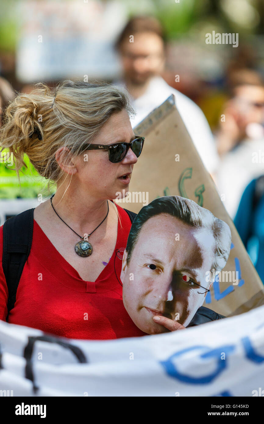 Bristol, UK, 8th May, 2016.  A protester is pictured carrying a David Cameron face mask as she takes part in the 'Going backwards for climate change' march. Credit:  lynchpics/Alamy Live News Stock Photo