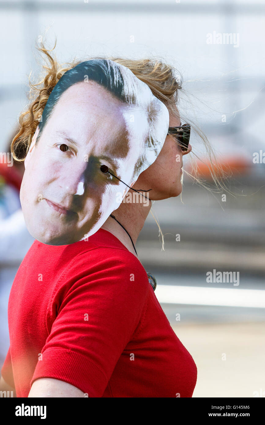 Bristol, UK, 8th May, 2016.  A protester is pictured wearing a David Cameron face mask as she listens to speeches at the end of the 'Going backwards for climate change' march. Credit:  lynchpics/Alamy Live News Stock Photo