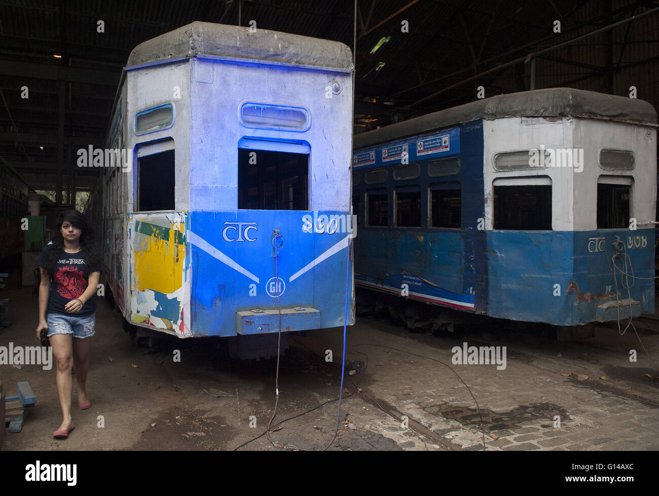 Kolkata, Indian state West Bengal. 8th May, 2016. A visitor walks beside tramcars during the two-day event Tram Tales at a tram depot in Kolkata, capital of eastern Indian state West Bengal, May 8, 2016. Tram Tales was planned as a unique mixed - media interactive visual installation piece using videos, music, photography, games, food and interaction to celebrate the nostalgia of trams as a symbol of Kolkata's rich colonial-era heritage. The event was held from May 7 to 8. © Tumpa Mondal/Xinhua/Alamy Live News Stock Photo