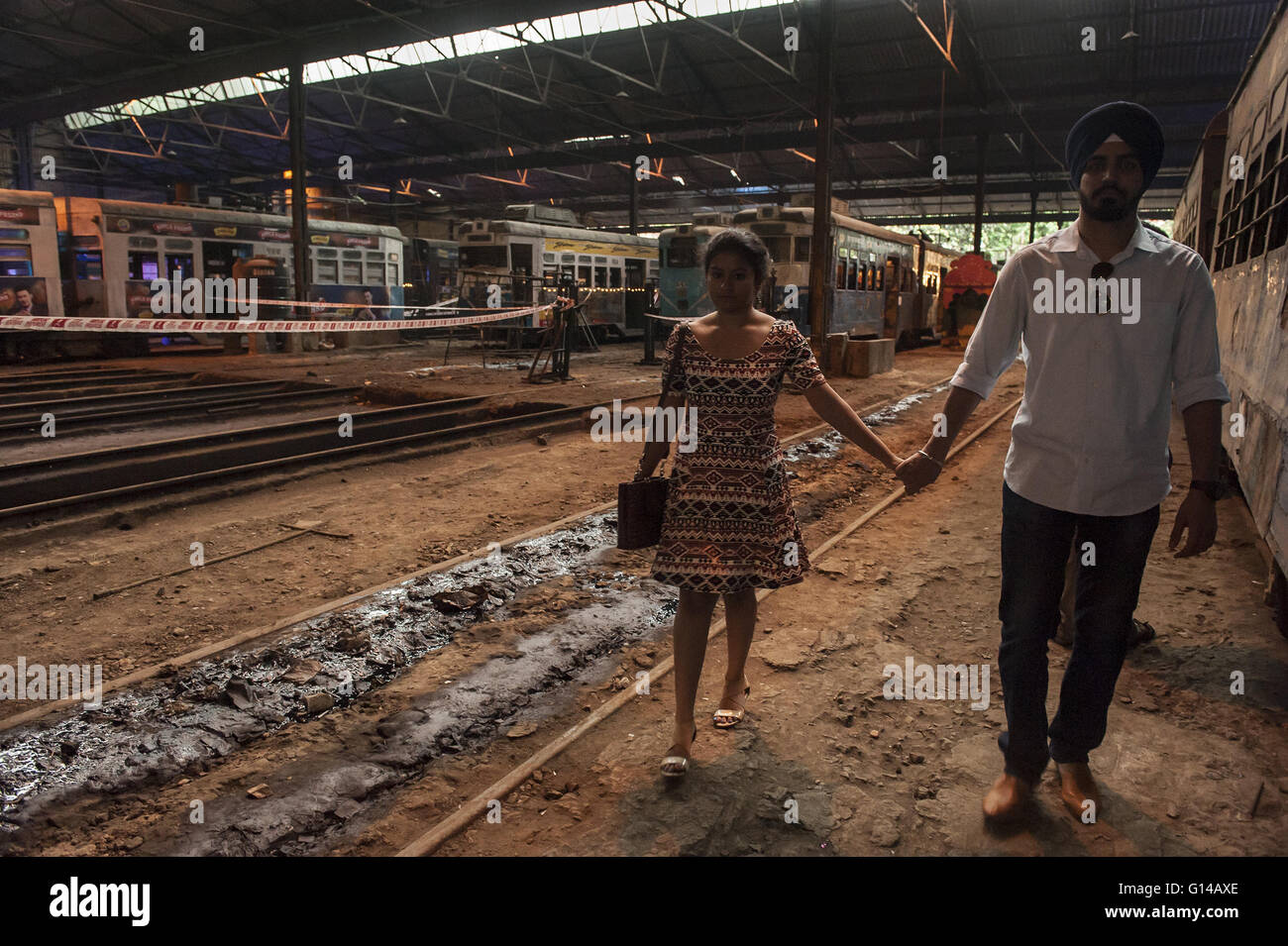 Kolkata, Indian state West Bengal. 8th May, 2016. A couple walk along a tram line during the two-day event Tram Tales at a tram depot in Kolkata, capital of eastern Indian state West Bengal, May 8, 2016. Tram Tales was planned as a unique mixed - media interactive visual installation piece using videos, music, photography, games, food and interaction to celebrate the nostalgia of trams as a symbol of Kolkata's rich colonial-era heritage. The event was held from May 7 to 8. © Tumpa Mondal/Xinhua/Alamy Live News Stock Photo