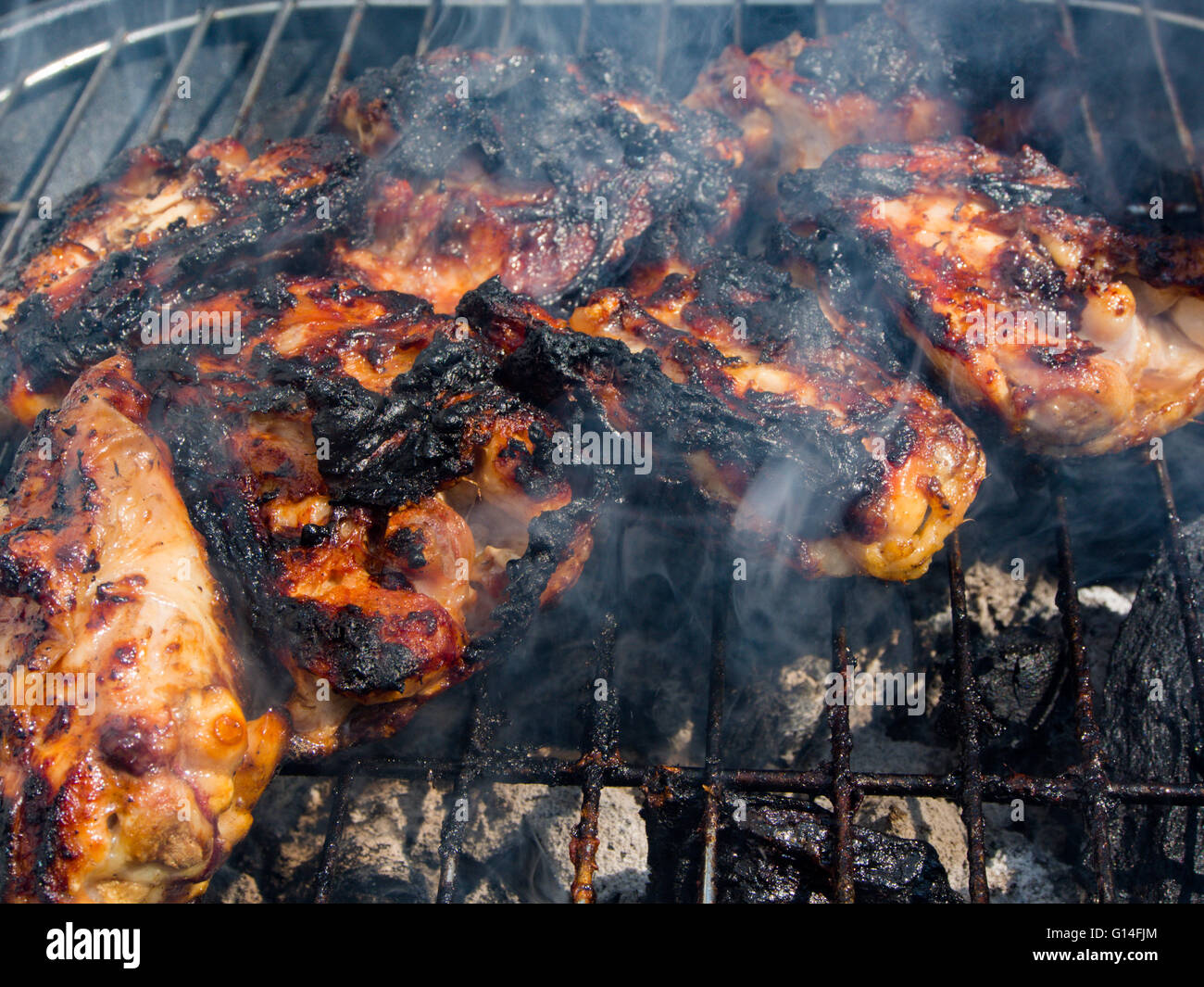 chargilled and burnt chicken pieces on a barbecue Stock Photo Alamy