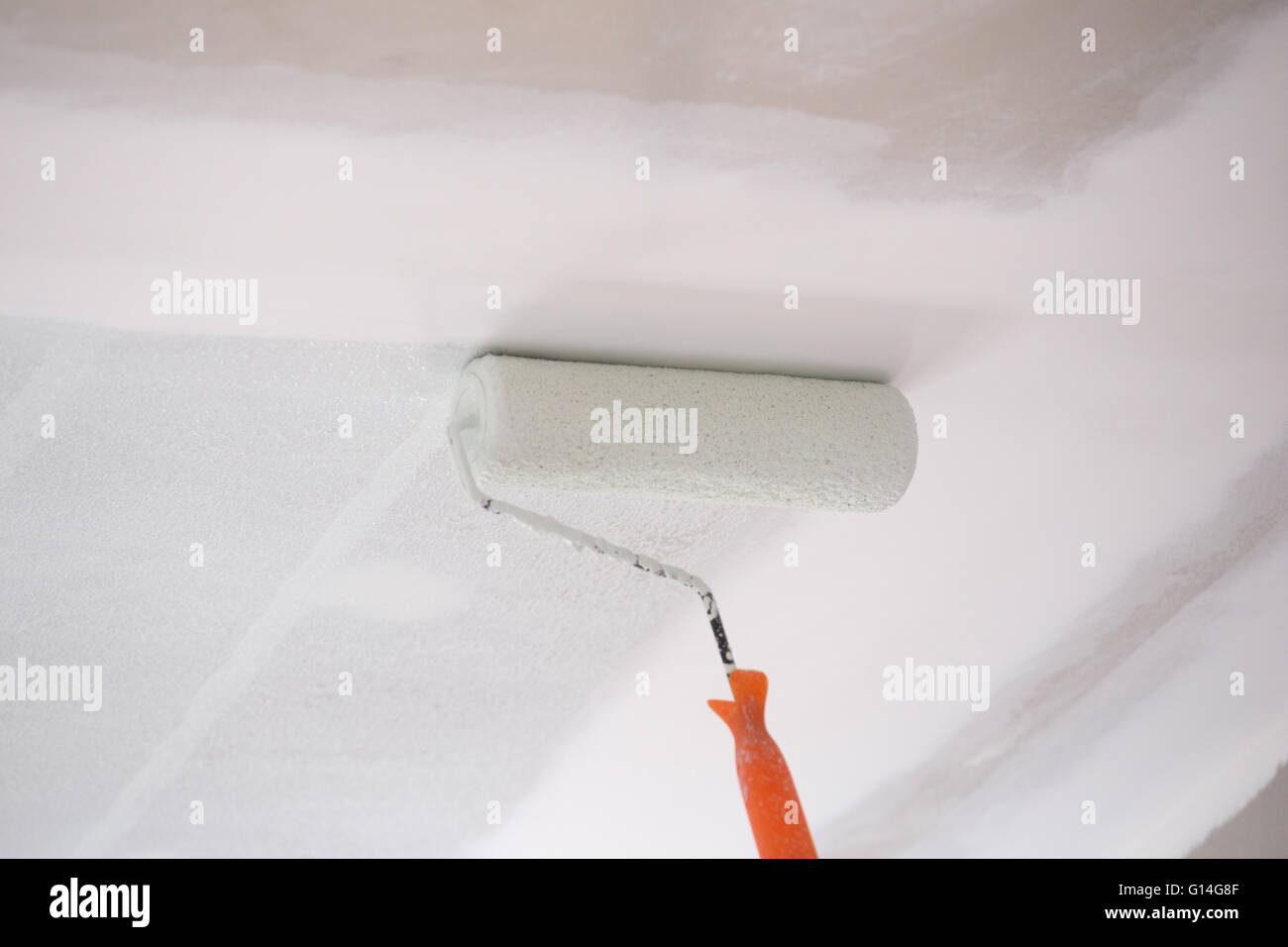 Painting A Gypsum Plaster Ceiling With Painting Roller Stock Photo