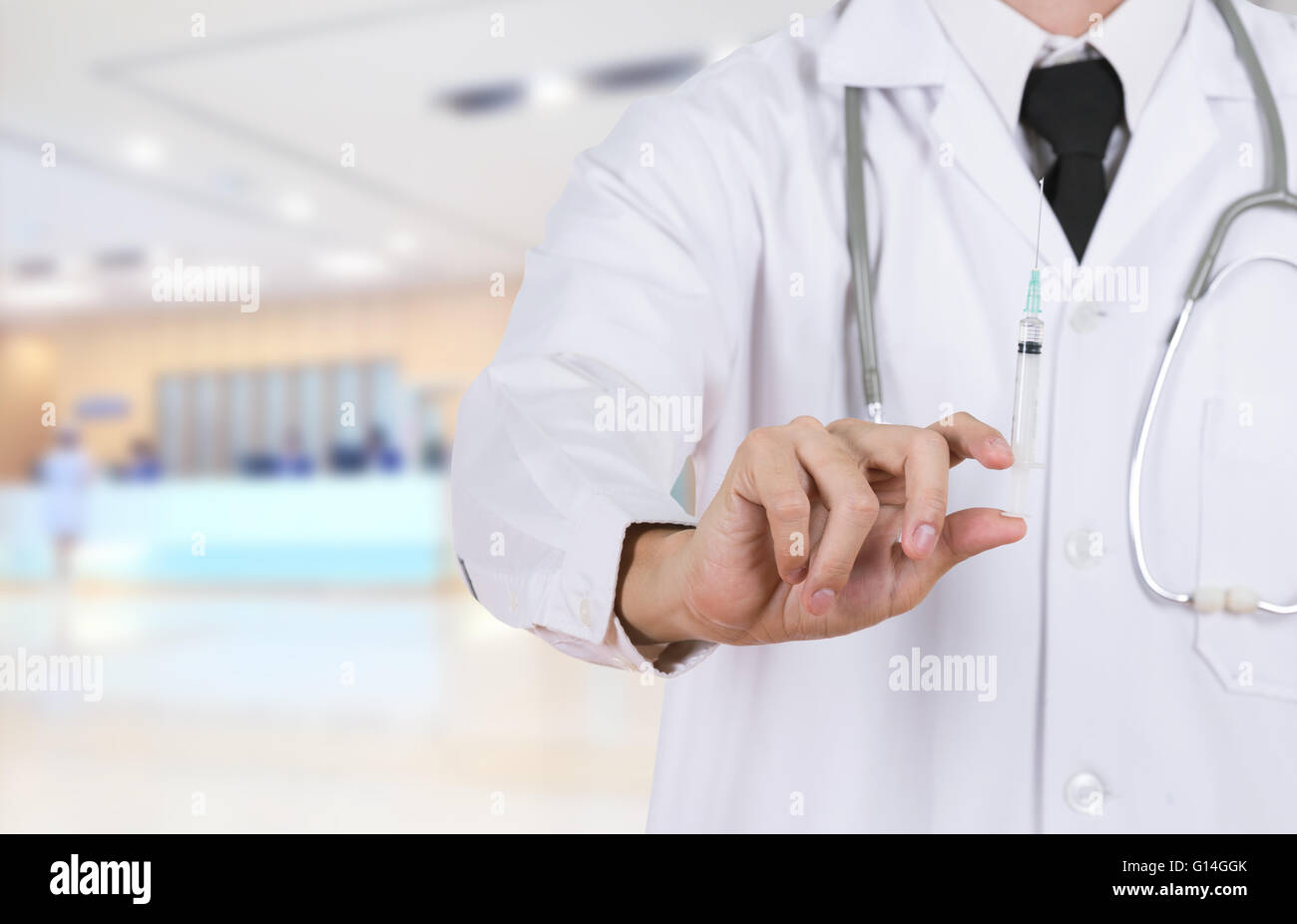 doctor holding syringe in hospital background Stock Photo - Alamy