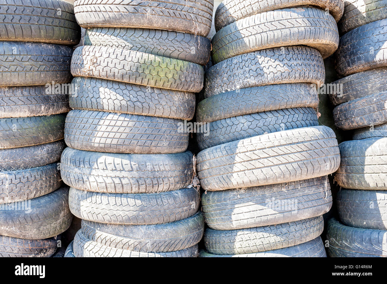Old used tires stacked with high piles Stock Photo