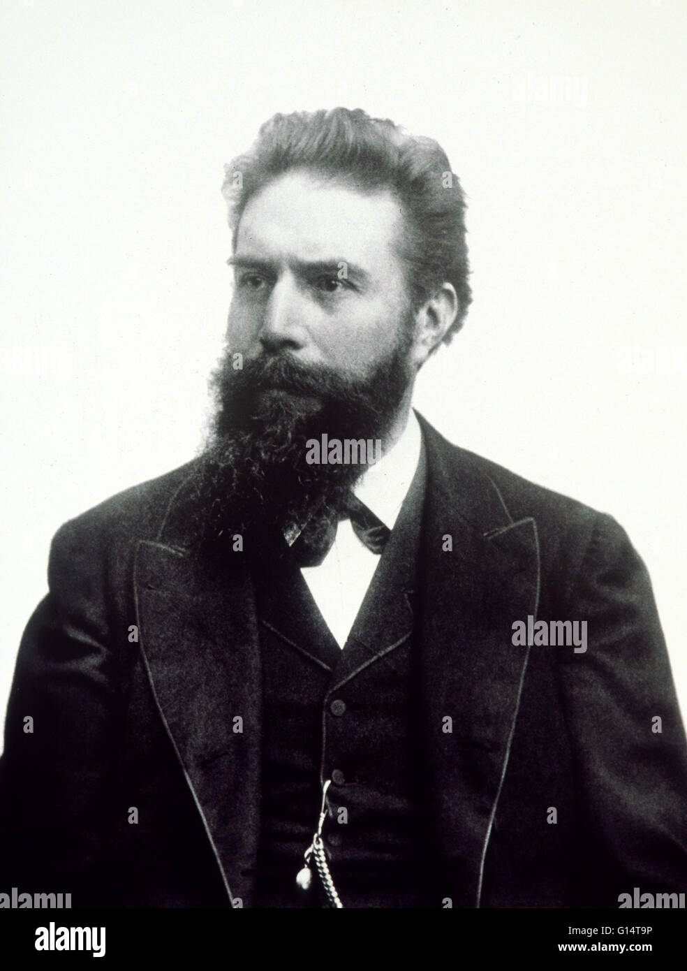 Wilhelm Konrad Roentgen (1845-1923), German experimental physicist and discoverer of X-rays. While using a discharge tube (in which an electric discharge is passed through a gas at low pressure) in a darkened room, Roentgen noticed that a card coated with Stock Photo