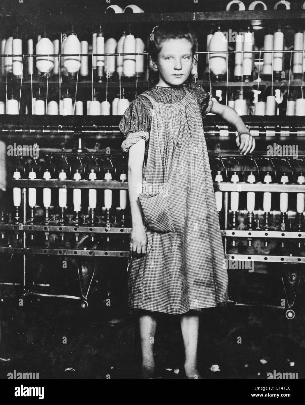 Entitled: 'Addie Card, 12 years. Spinner in North Pownal Cotton Mill. Girls in mill say she is ten years. She admitted to me she was twelve; that she started during school vacation and now would stay. Location: North Pownal, Vermont.' Photographed by Lewi Stock Photo