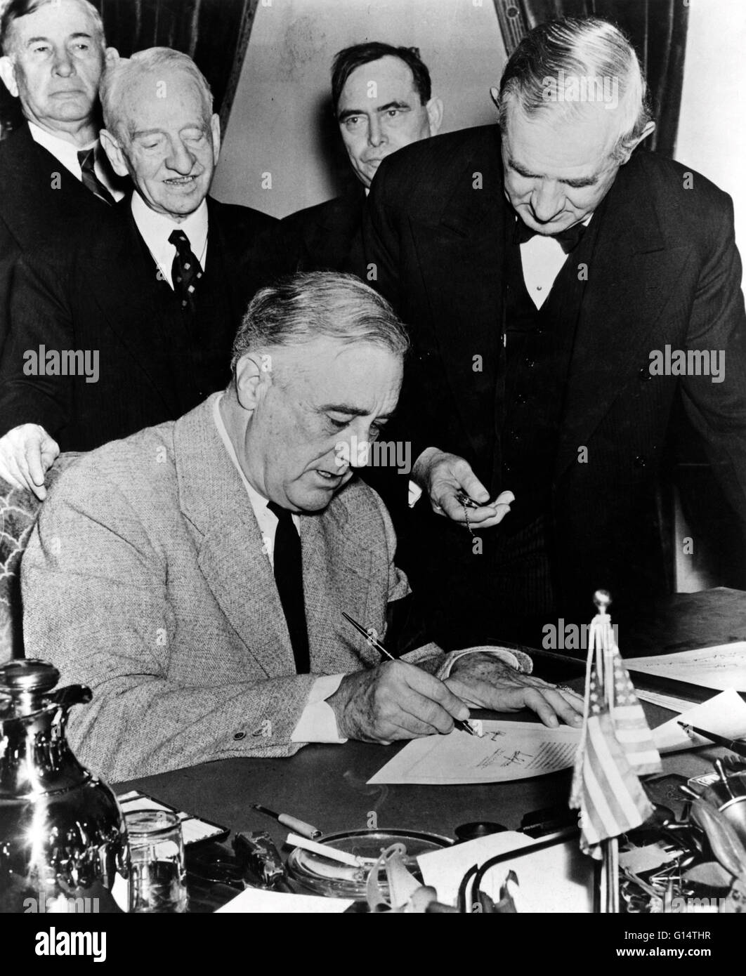 President Roosevelt signing the declaration of war against Japan in 1941. Franklin Delano Roosevelt (January 30, 1882 - April 12, 1945) was the 32nd President of the United States (1933-1945) and a central figure in world events during the mid-20th centur Stock Photo
