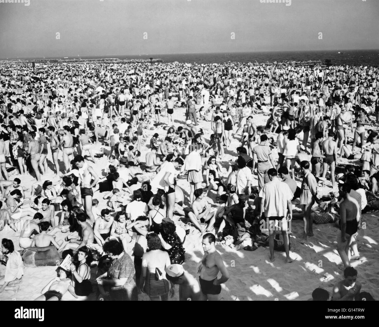 Beachgoers crowd Coney Island, New York, in 1941. Photogreaph by Alfred Palmer. Stock Photo