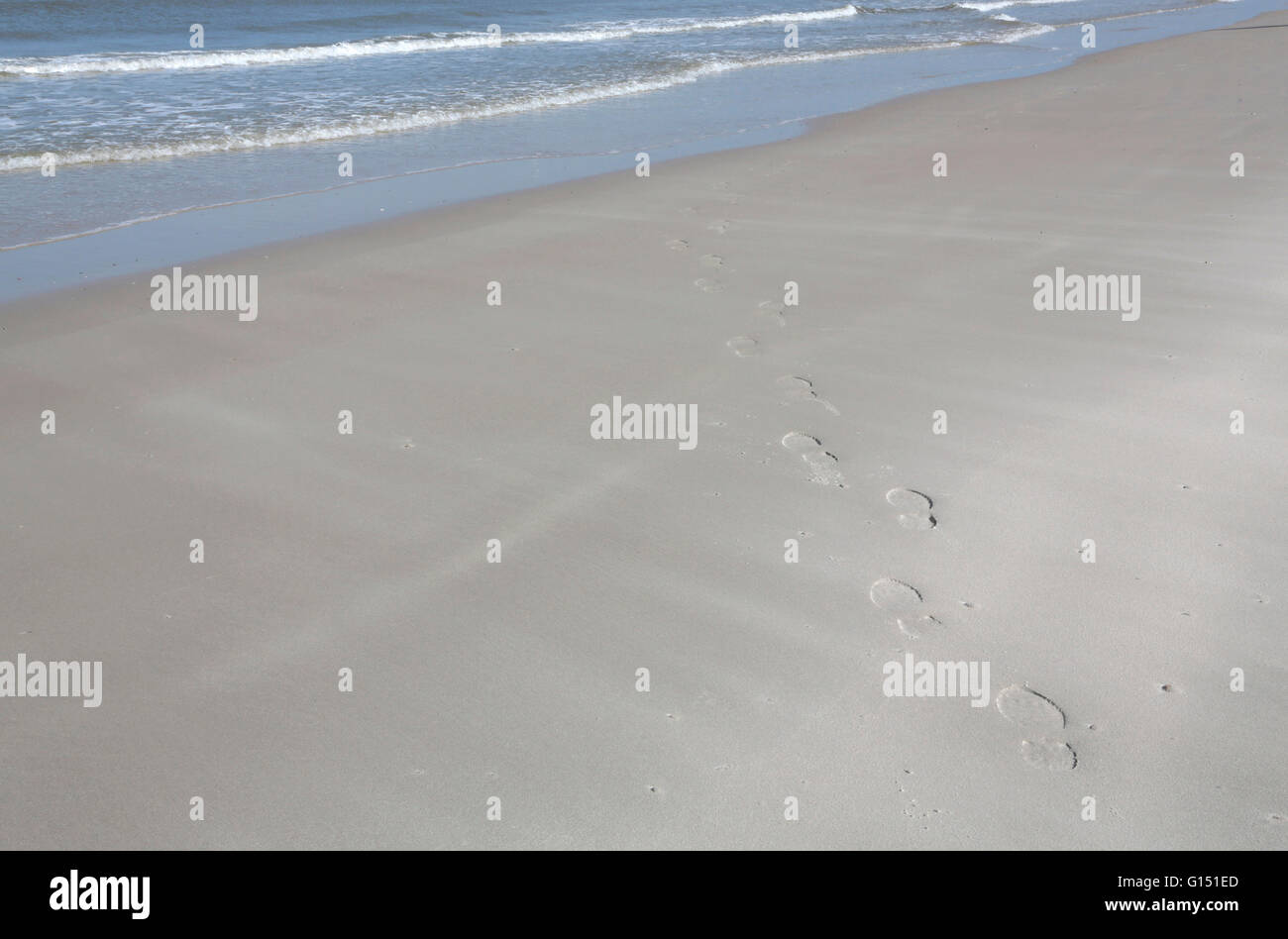 Footprints leading to the sea Stock Photo