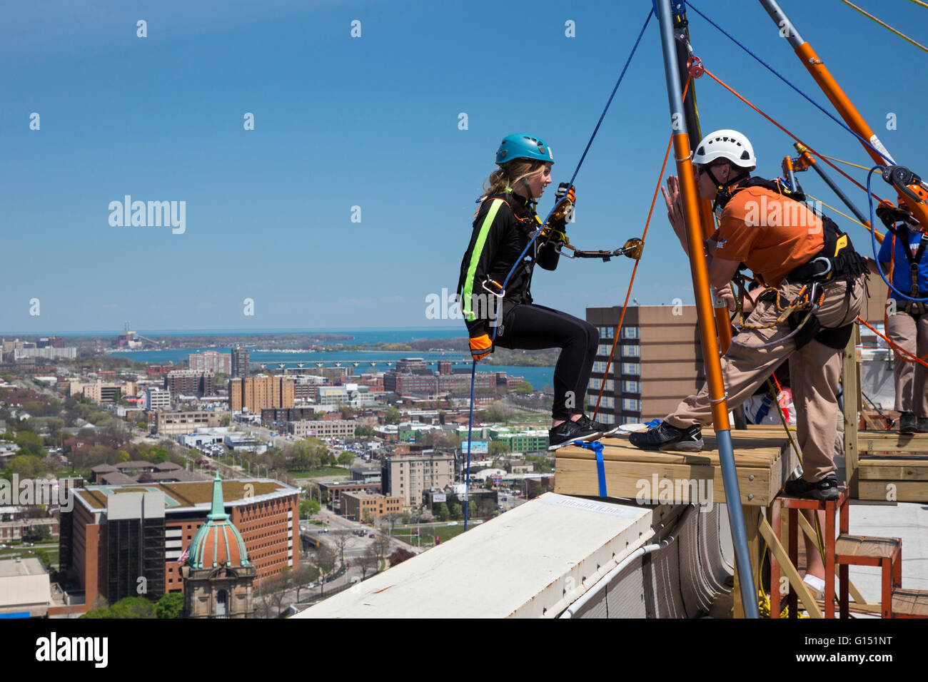 Detroit, Michigan - People rappel down a 25-story building as a fundraiser to benefit charities in Detroit and Nepal. Stock Photo