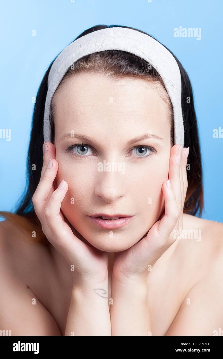 Portrait of a woman with hands on cheeks Stock Photo
