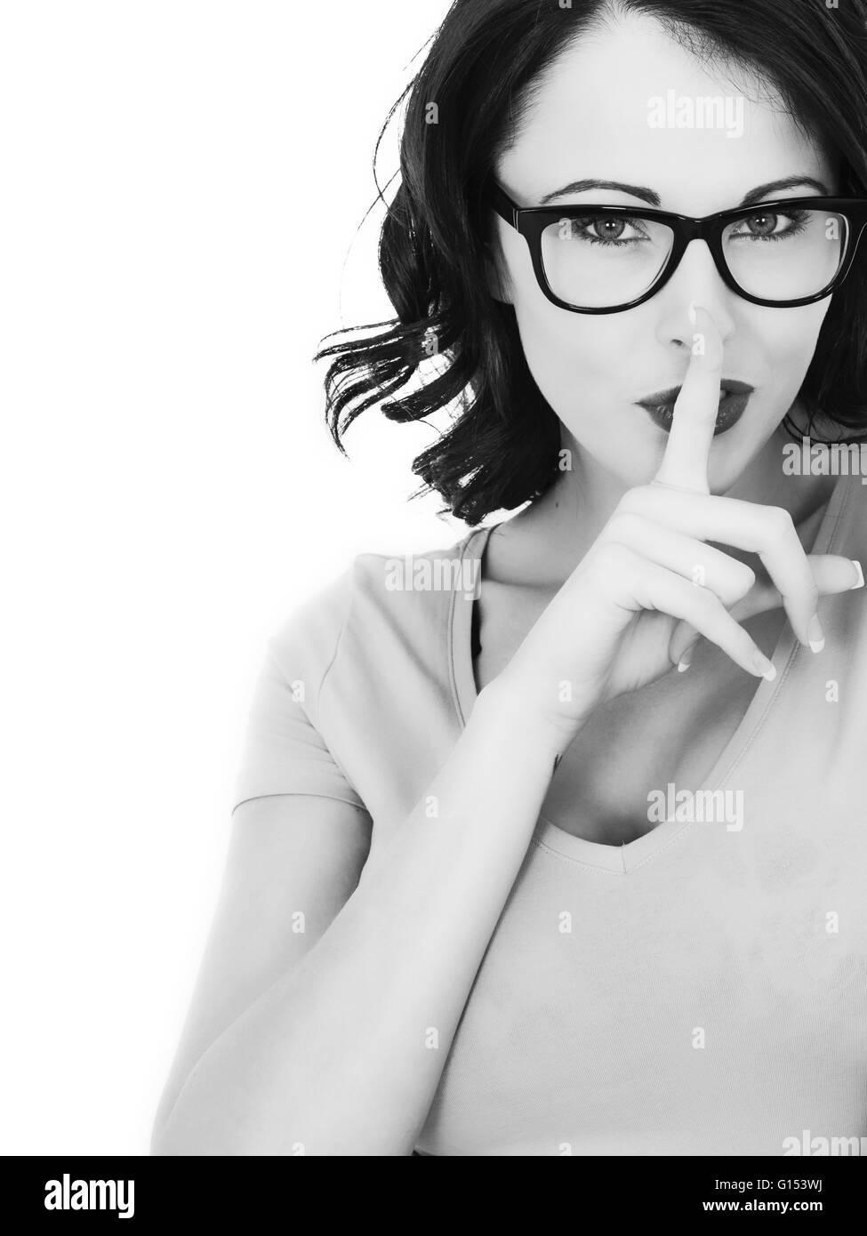Portrait of a Woman Keeping a Secret With Her Finger Covering Her Lips Stock Photo