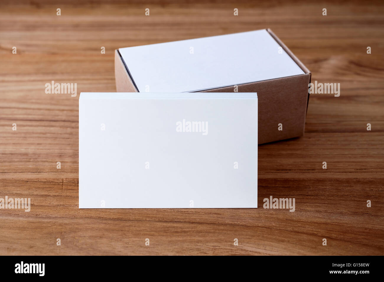 Business card blank mockup with kraft box on wood desk Stock Photo