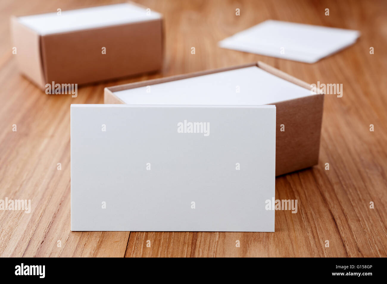 Business card blank mockup with kraft box on wood desk Stock Photo
