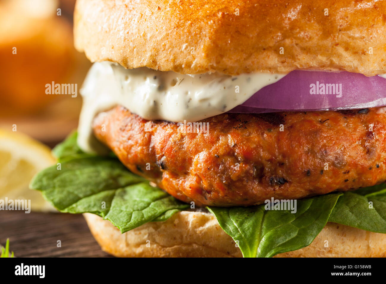 Homemade Salmon Burger with Tartar Sauce and Onion Stock Photo Alamy
