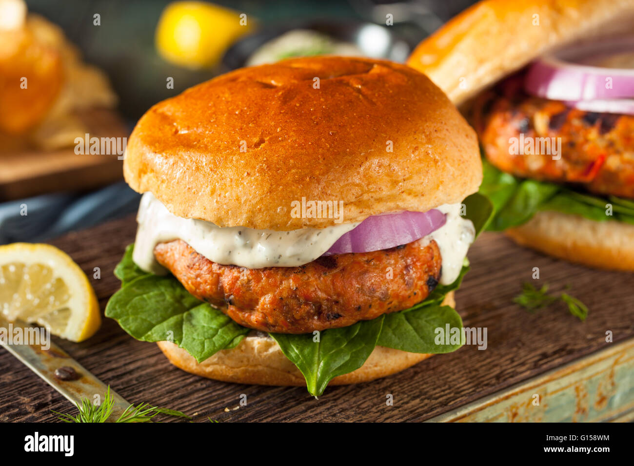Homemade Salmon Burger with Tartar Sauce and Onion Stock Photo Alamy