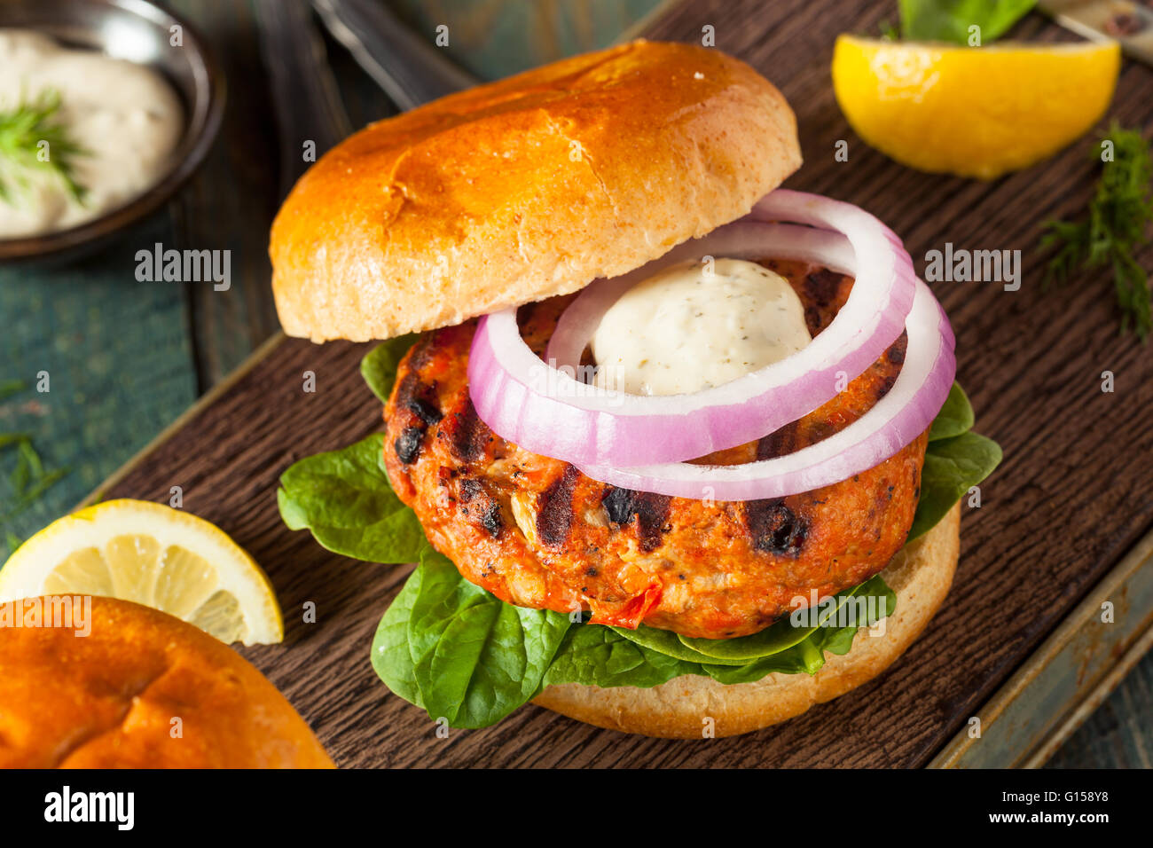 Homemade Salmon Burger with Tartar Sauce and Onion Stock Photo Alamy