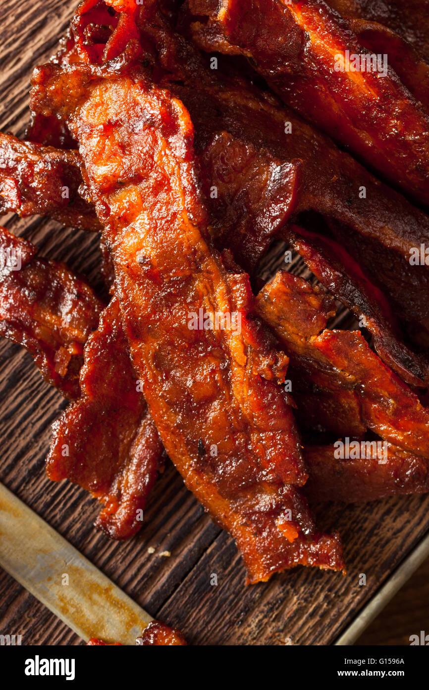 Homemade Dried Barbecue Bacon Jerky with Salt Stock Photo