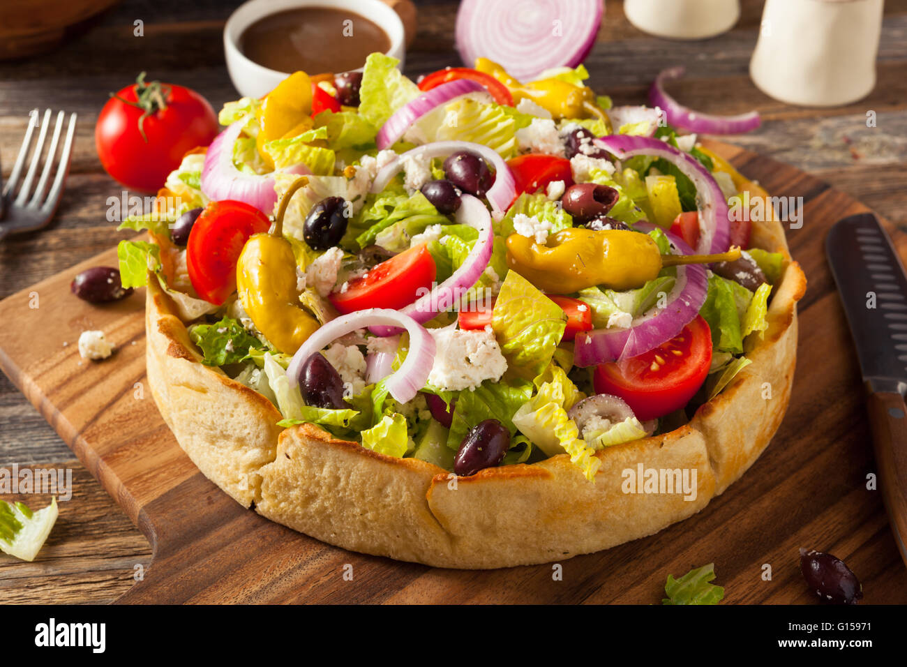 Homemade Greek Salad in a Bread Bowl with Onions and Peppers Stock
