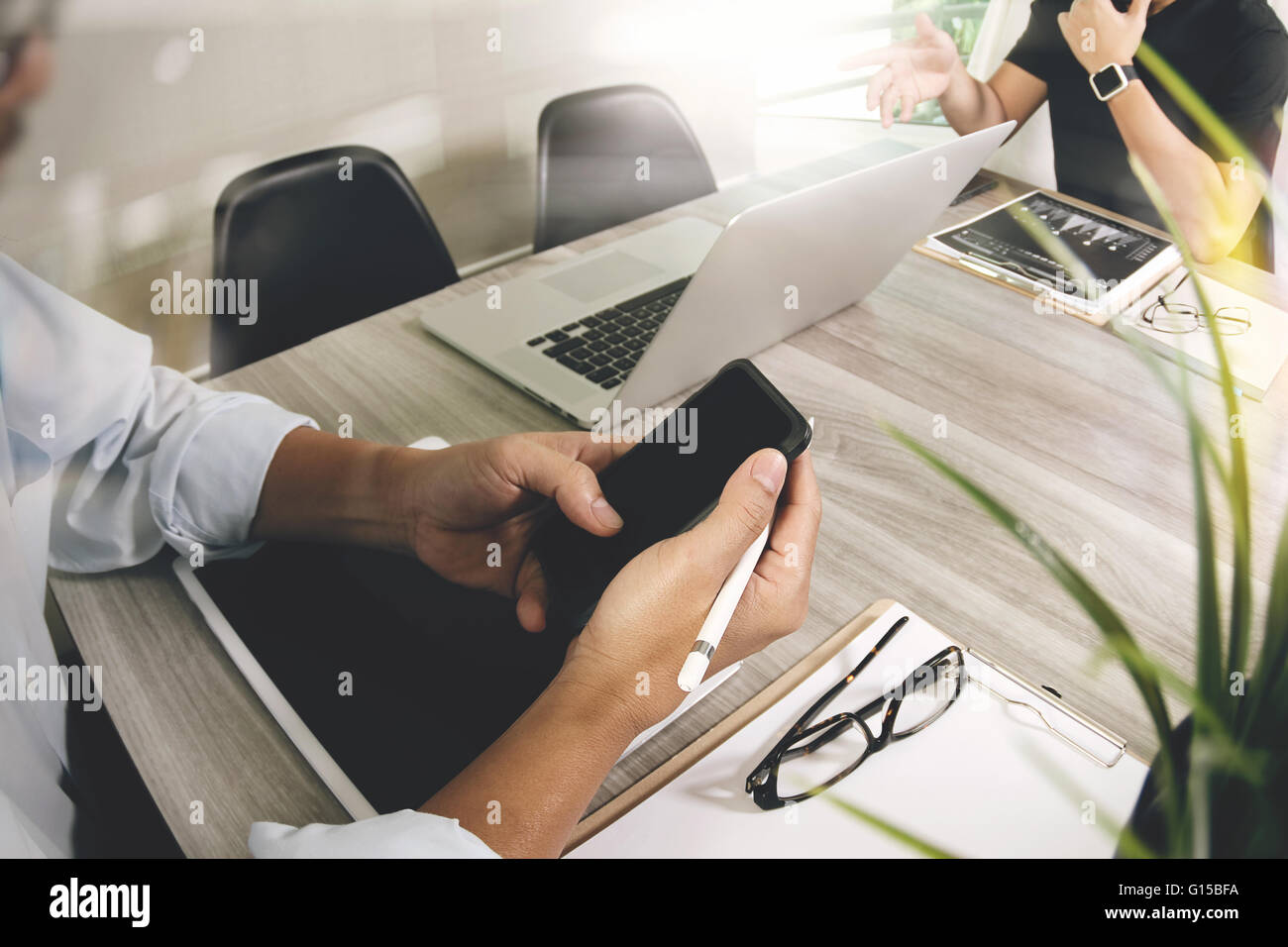 Businessman making presentation and using smart phone with his ...